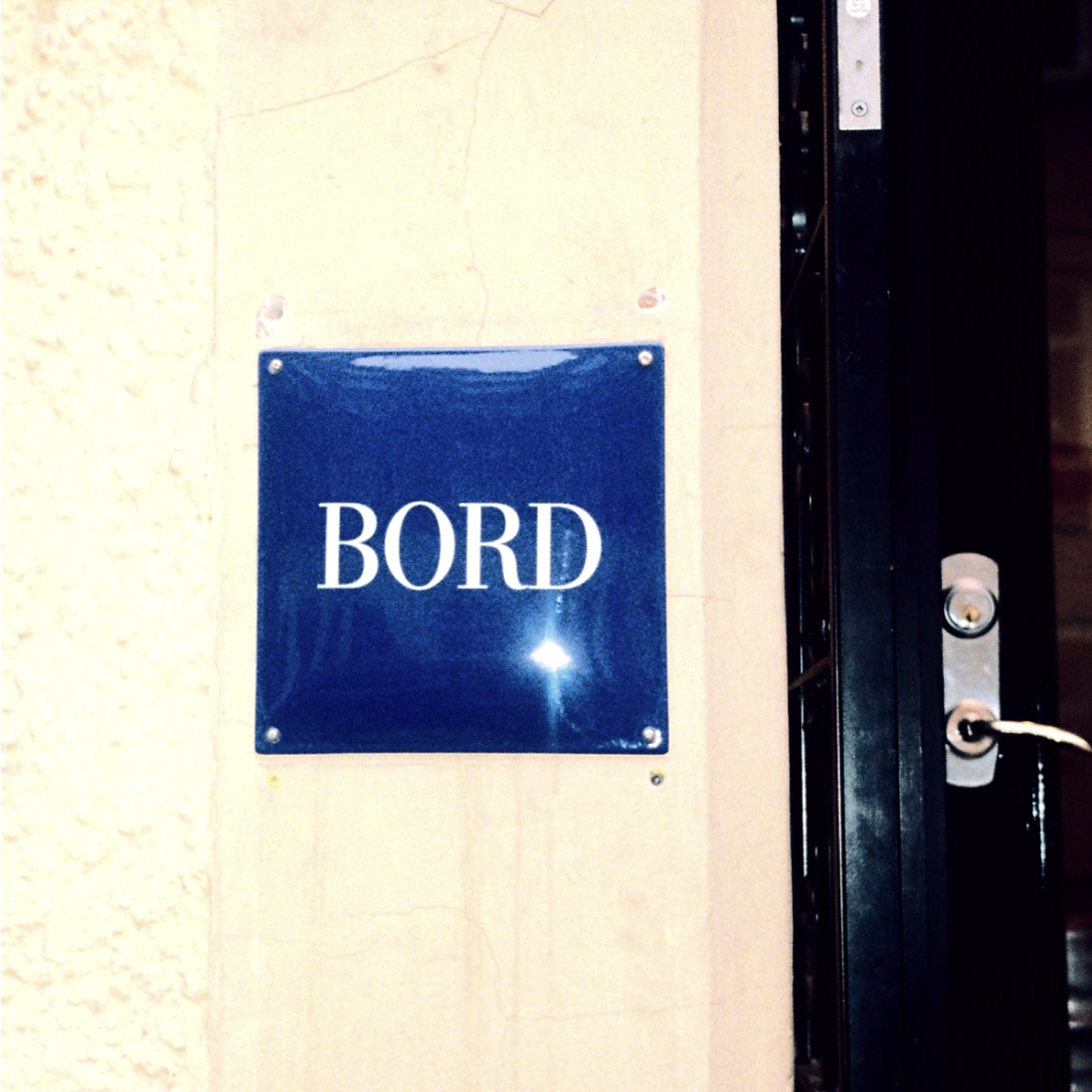 Blue enamel BORD sign at the restaurant entrance